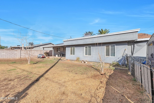 rear view of property featuring a yard