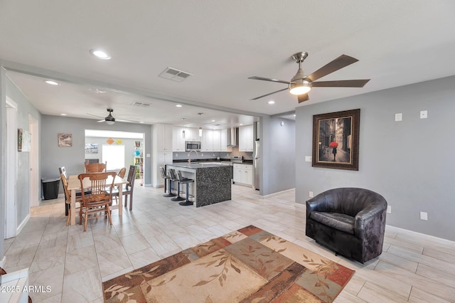 living room with sink and ceiling fan