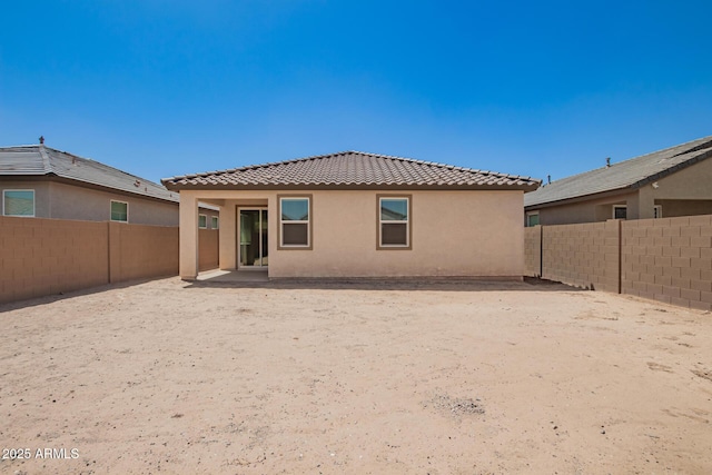 3036 E Riding Boot Way, San Tan Valley, AZ 85140 - rear view of house featuring a tile roof, stucco siding, and a fenced backyard
