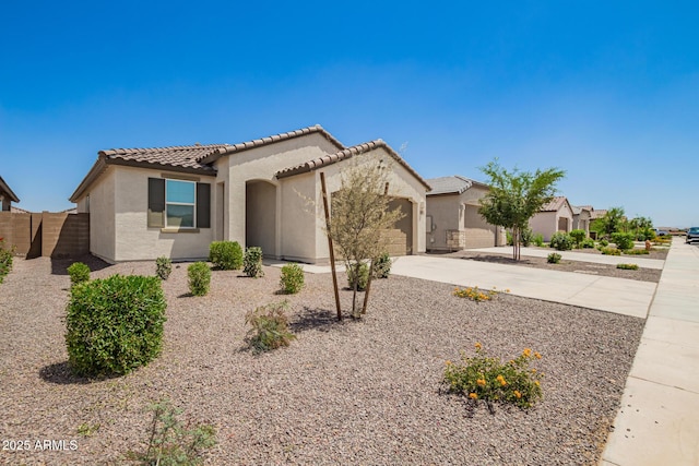 3036 E Riding Boot Way, San Tan Valley, AZ 85140 - mediterranean / spanish house with an attached garage, stucco siding, driveway, a tile roof, and fence