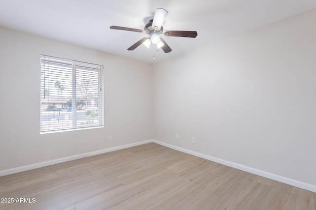 unfurnished room with light wood-style flooring, baseboards, and a ceiling fan