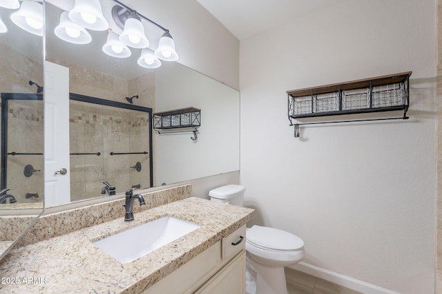 full bathroom with a shower stall, toilet, vanity, and baseboards