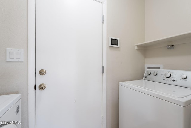 washroom with independent washer and dryer