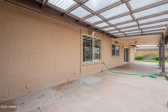 view of patio featuring a ceiling fan and fence