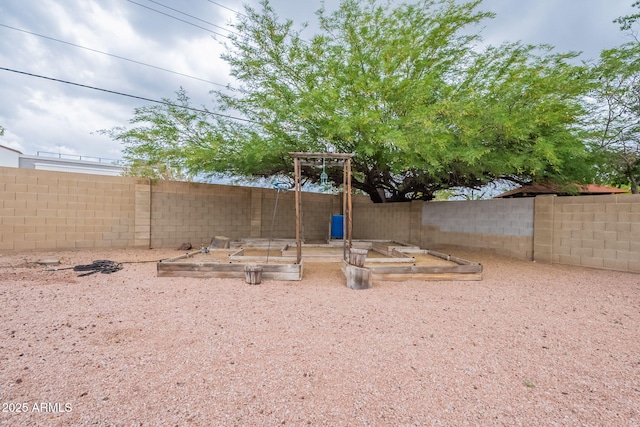 fenced backyard featuring a garden