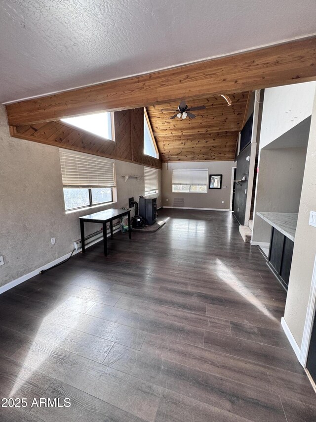 bonus room featuring dark wood finished floors, plenty of natural light, and baseboards