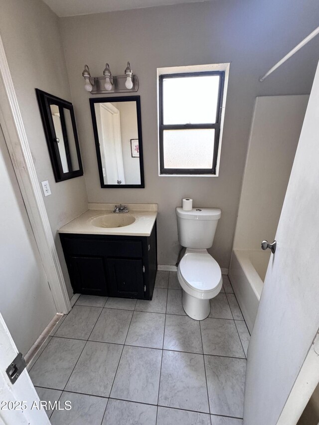 bathroom with toilet, vanity, shower / tub combination, tile patterned flooring, and baseboards