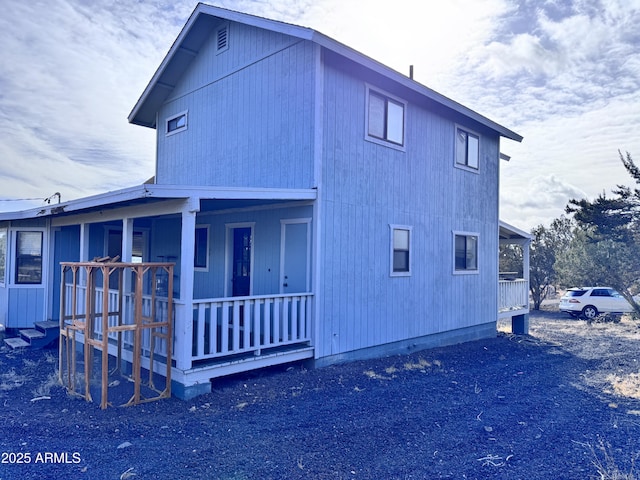 view of side of home with a porch