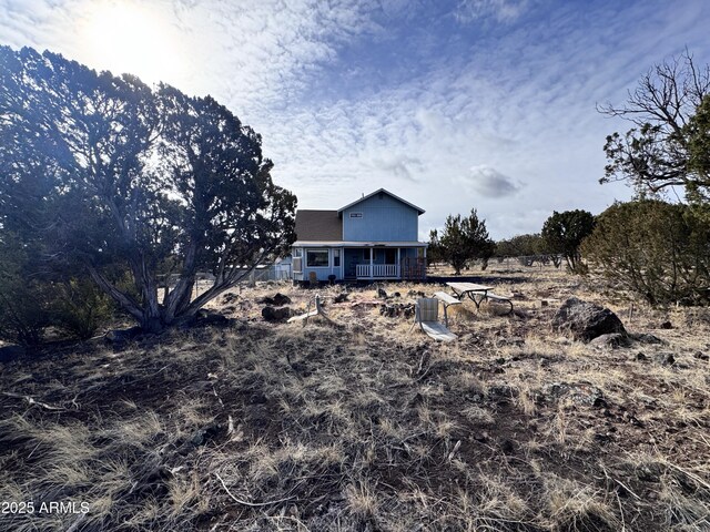 rear view of house featuring covered porch