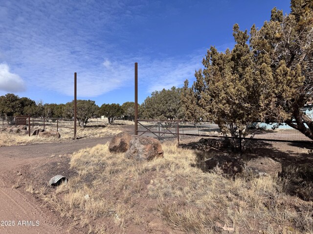 view of yard featuring a rural view and fence