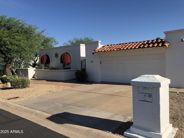 38 E Calavar Rd, Phoenix, AZ 85022 - view of front of home featuring driveway, a tiled roof, an attached garage, and stucco siding
