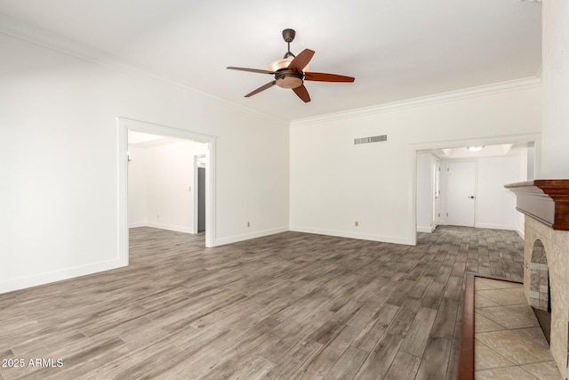 38 E Calavar Rd, Phoenix, AZ 85022 - unfurnished living room with wood finished floors, crown molding, ceiling fan, and a tile fireplace