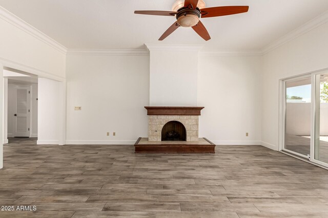 38 E Calavar Rd, Phoenix, AZ 85022 - unfurnished living room featuring ornamental molding, a ceiling fan, wood finished floors, and a fireplace