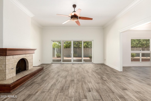 38 E Calavar Rd, Phoenix, AZ 85022 - unfurnished living room with healthy amount of natural light, ceiling fan, wood finished floors, ornamental molding, and a fireplace