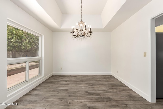 38 E Calavar Rd, Phoenix, AZ 85022 - spare room with a tray ceiling, a chandelier, and wood finished floors
