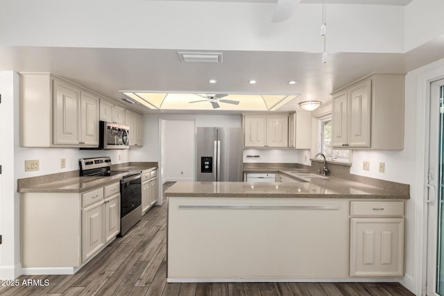 38 E Calavar Rd, Phoenix, AZ 85022 - kitchen with stainless steel appliances, a ceiling fan, a peninsula, wood finished floors, and recessed lighting