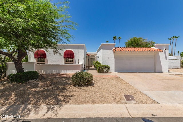 38 E Calavar Rd, Phoenix, AZ 85022 - view of front of house featuring stucco siding, a gate, a tile roof, driveway, and an attached garage
