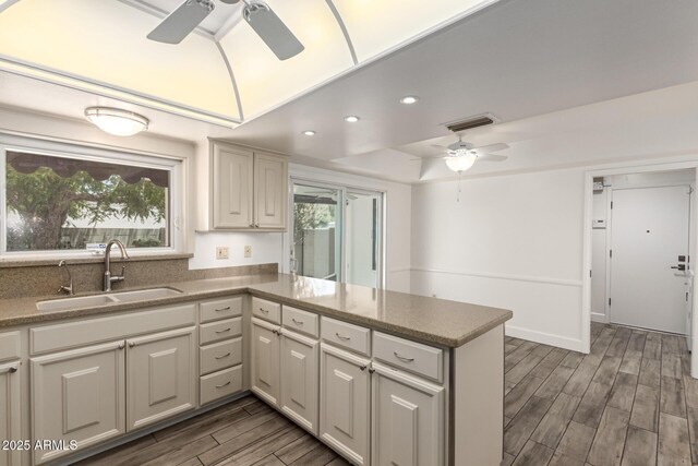 38 E Calavar Rd, Phoenix, AZ 85022 - kitchen with ceiling fan, a tray ceiling, wood finished floors, a peninsula, and recessed lighting