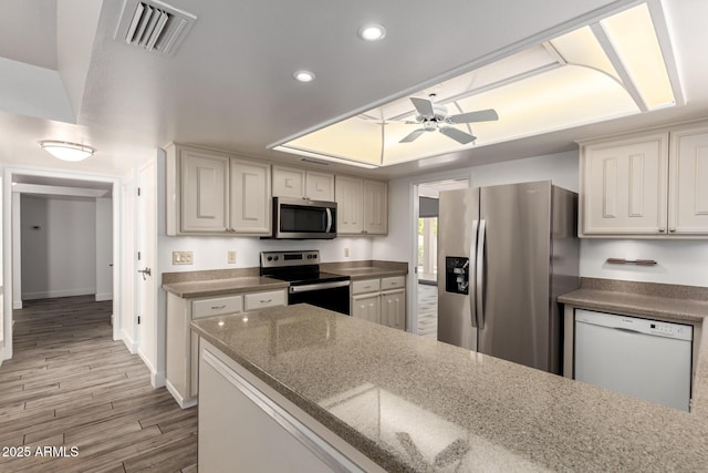 38 E Calavar Rd, Phoenix, AZ 85022 - kitchen with stainless steel appliances, ceiling fan, recessed lighting, light wood-type flooring, and dark stone countertops