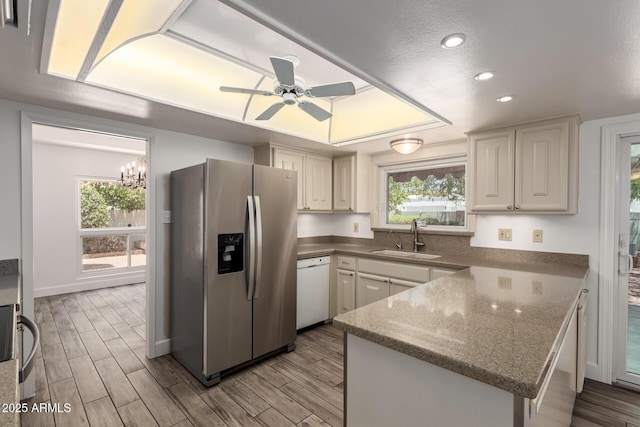 38 E Calavar Rd, Phoenix, AZ 85022 - kitchen with stainless steel fridge with ice dispenser, dishwasher, a peninsula, wood finished floors, and recessed lighting