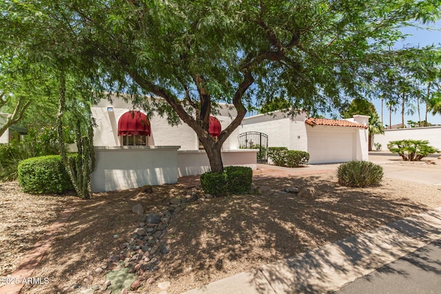 38 E Calavar Rd, Phoenix, AZ 85022 - view of home's exterior featuring stucco siding, driveway, and a tiled roof