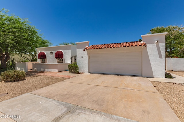 38 E Calavar Rd, Phoenix, AZ 85022 - view of front of house featuring an attached garage, driveway, stucco siding, and a tiled roof