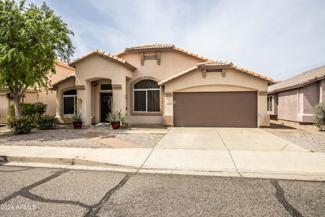 mediterranean / spanish home featuring a garage