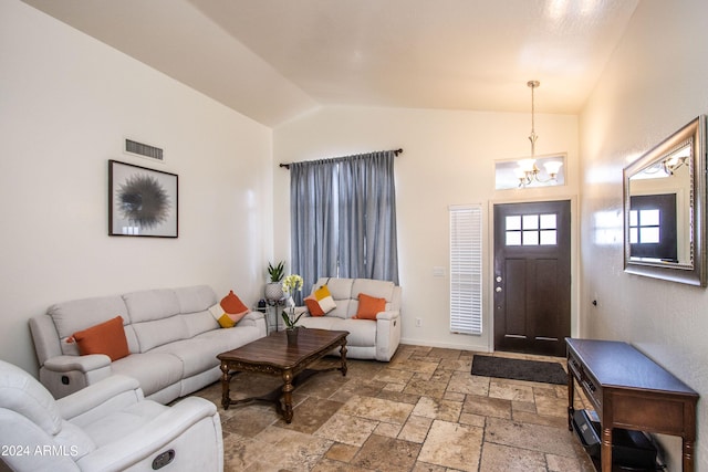 foyer featuring a notable chandelier and vaulted ceiling