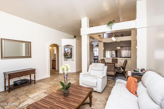 living room featuring ceiling fan and high vaulted ceiling