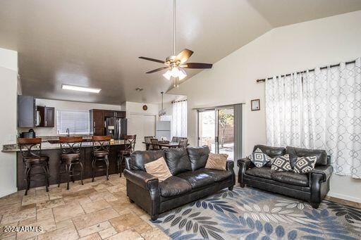 living room with lofted ceiling and ceiling fan