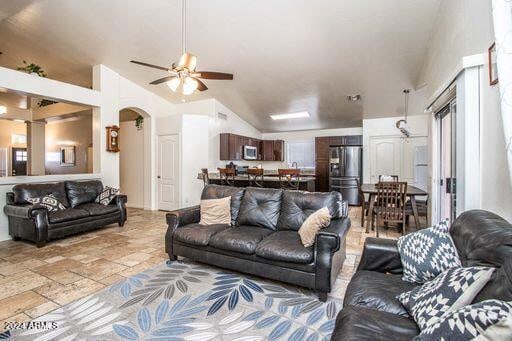 living room with lofted ceiling and ceiling fan