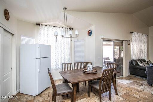 dining area featuring vaulted ceiling