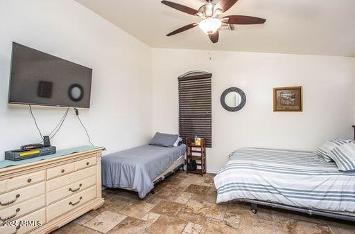 bedroom featuring ceiling fan and vaulted ceiling