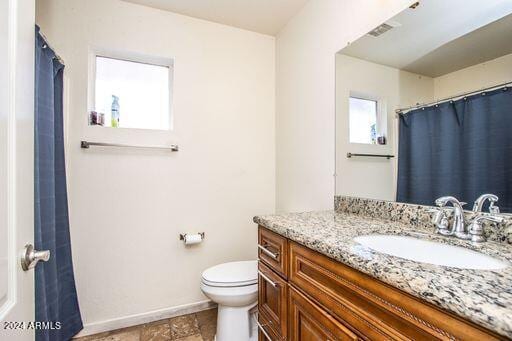 bathroom featuring vanity and toilet