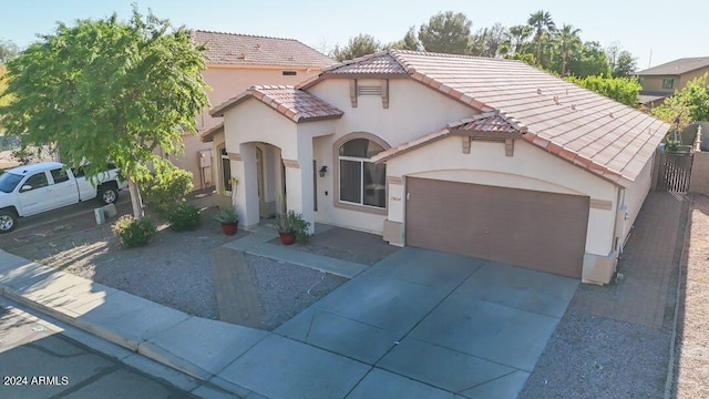 mediterranean / spanish house with a garage