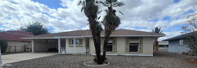 13816 N 103rd Ave, Sun City, AZ 85351 - ranch-style home featuring brick siding, covered porch, an attached garage, fence, and driveway