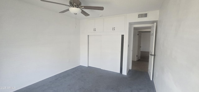 13816 N 103rd Ave, Sun City, AZ 85351 - unfurnished bedroom with a ceiling fan, visible vents, dark carpet, and a closet