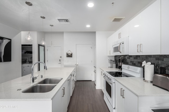 kitchen with pendant lighting, tasteful backsplash, white cabinetry, sink, and white appliances