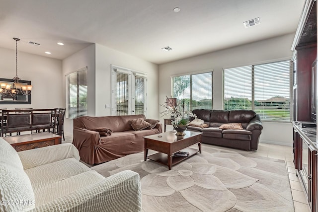 27105 W Marco Polo Rd, Buckeye, AZ 85396 - living area with a chandelier, light tile patterned floors, healthy amount of natural light, recessed lighting, and baseboards
