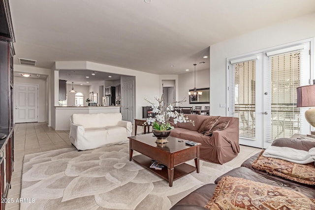 27105 W Marco Polo Rd, Buckeye, AZ 85396 - living room featuring a chandelier and light tile patterned floors