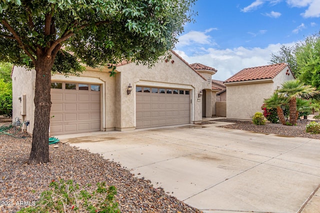 27105 W Marco Polo Rd, Buckeye, AZ 85396 - mediterranean / spanish-style home featuring stucco siding, driveway, a tile roof, and an attached garage