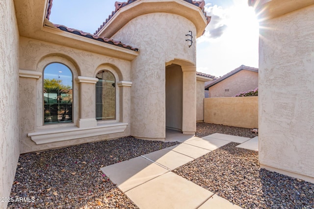 27105 W Marco Polo Rd, Buckeye, AZ 85396 - entrance to property featuring a tile roof, fence, and stucco siding