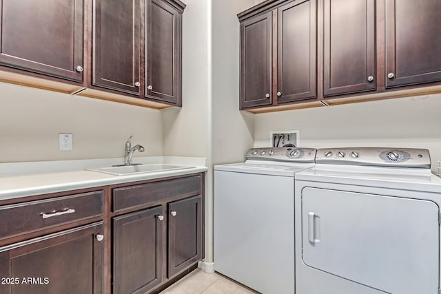 27105 W Marco Polo Rd, Buckeye, AZ 85396 - clothes washing area featuring washer and dryer, cabinet space, and light tile patterned floors