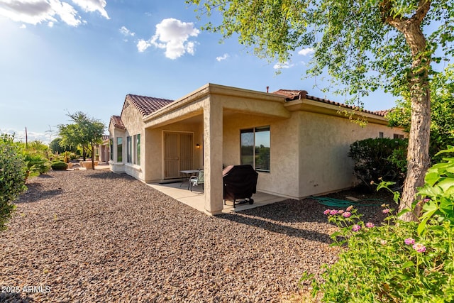 27105 W Marco Polo Rd, Buckeye, AZ 85396 - back of property with stucco siding, a tiled roof, and a patio area