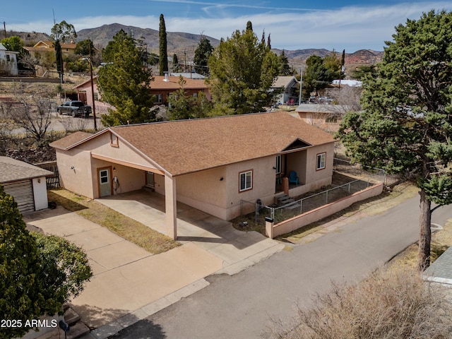 view of front of home with a carport and a mountain view