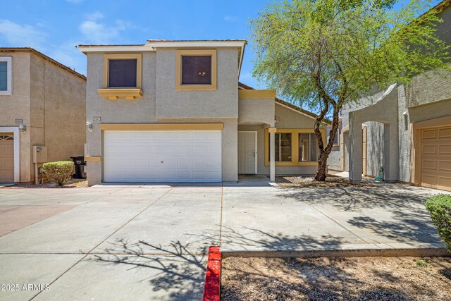 1236 S Boulder St Unit C, Gilbert, AZ 85296 - view of front facade featuring stucco siding, concrete driveway, and a garage