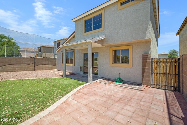 1236 S Boulder St Unit C, Gilbert, AZ 85296 - rear view of house featuring stucco siding, a fenced backyard, a patio area, and a gate