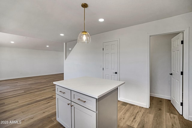 1236 S Boulder St Unit C, Gilbert, AZ 85296 - kitchen with light wood-style floors, decorative light fixtures, a kitchen island, light countertops, and recessed lighting