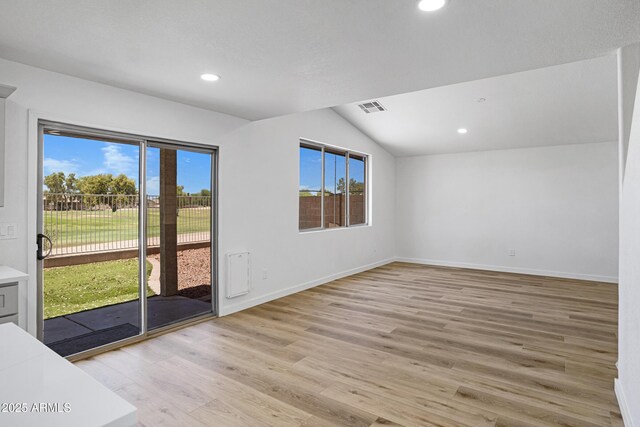 1236 S Boulder St Unit C, Gilbert, AZ 85296 - spare room with plenty of natural light, vaulted ceiling, light wood finished floors, and recessed lighting