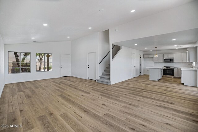 1236 S Boulder St Unit C, Gilbert, AZ 85296 - unfurnished living room featuring lofted ceiling, light wood-type flooring, recessed lighting, and stairway